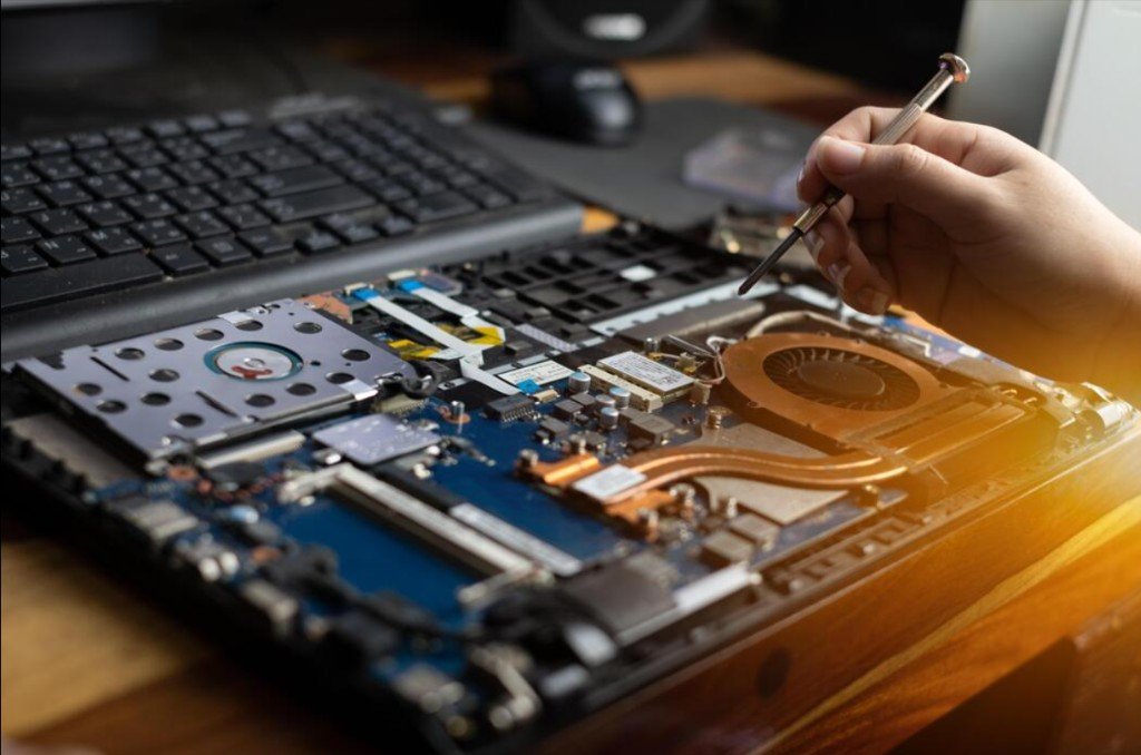 Close-up of a technician working on a laptop motherboard
